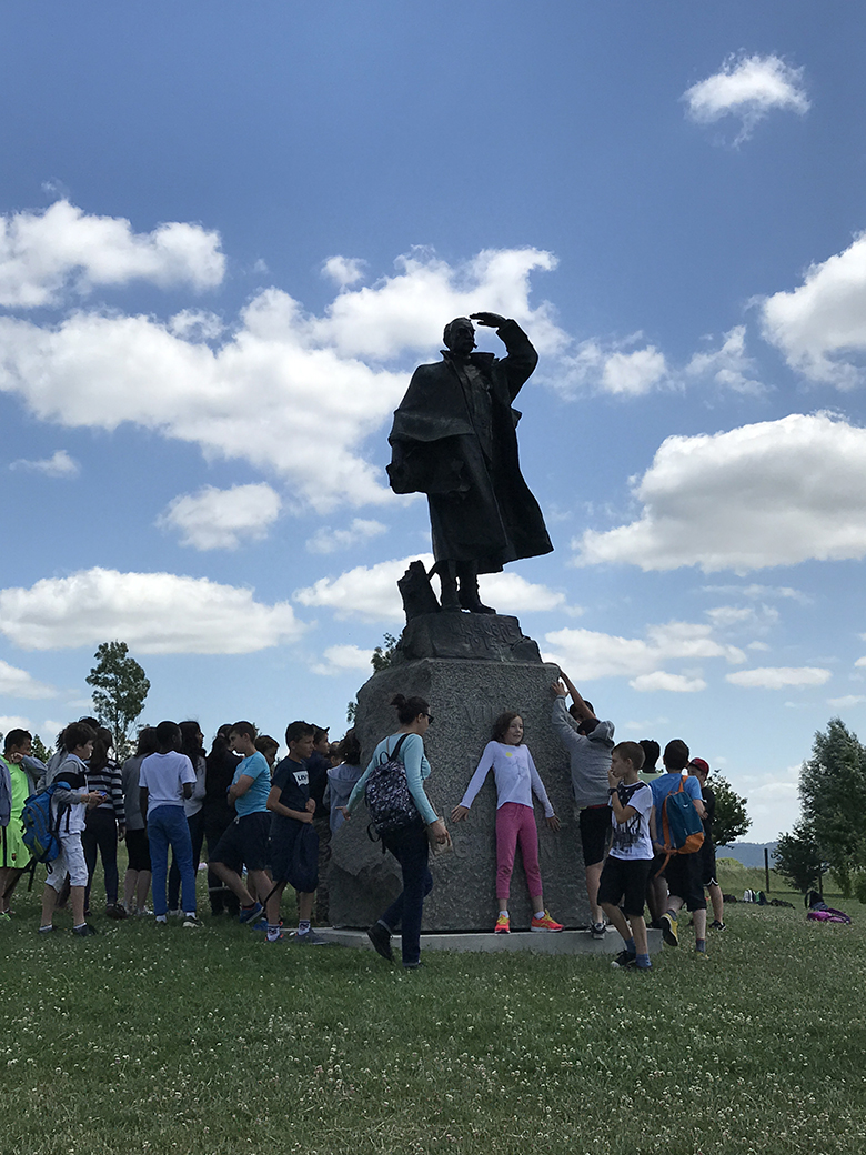 School children gather around the General Gallieni statue on the grounds the  Museé de la Grande Guerre de Meaux 